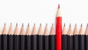 Red Pencil Standing Out From Black Pencils. Branding Tips for Businesses