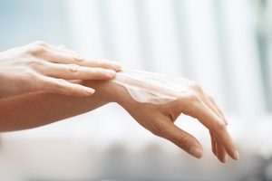 hands using lotion