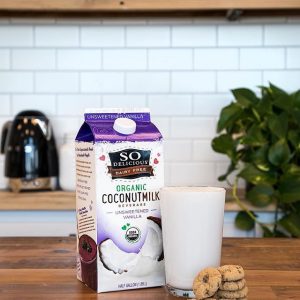 So Delicious Organic Unsweetened Coconut Milk---Vanilla in a glass with cookies