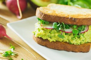 Green vegetable sandwich on Canyon Bakehouse frozen bread.