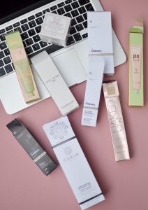 beauty products arranged on laptop