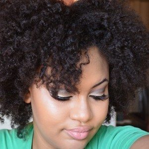 An African-American woman wears her natural textured hair