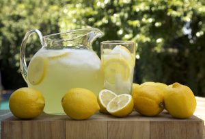 lemonade pitcher and glass with lemons