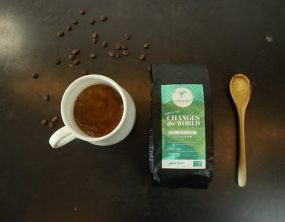 Coexist non-GMO coffee with cup and spoon