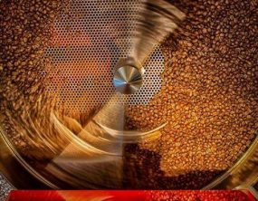 Coffee spins in a coffee roaster at the Cafe Altura processing facility.