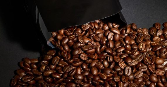 Coffee beans pour out of a Kicking Horse bag