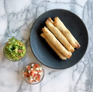 Starlite taquitos on plate with guac and salsa
