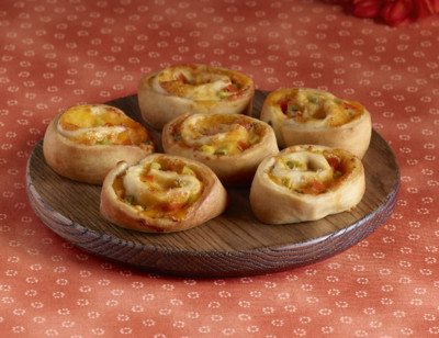 Amy's Cheddar Jalapeno Swirls on a brown plate. The plate sits on a red floral tablecloth.