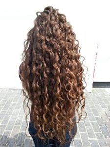 woman facing away from camera with really long, curly hair
