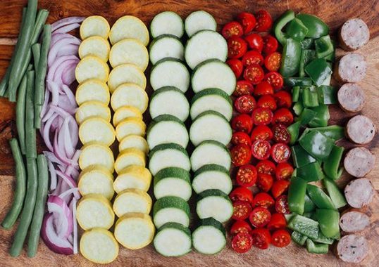 an array of veggies arranged in a row