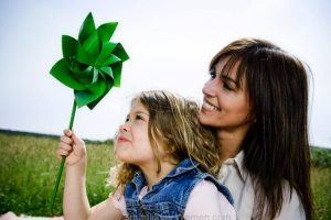 mother and daughter outdoors with green pinwheel