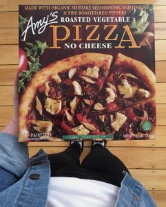Person holds an Amy's Roasted Vegetable Pizza
