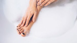 a woman washing herself with natural soaps