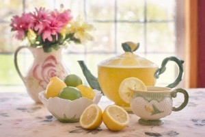 Teapot with dish of lemons and limes