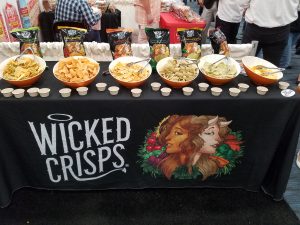 Row of Wicked Crisps bowls and bags at their Expo West 2018 booth