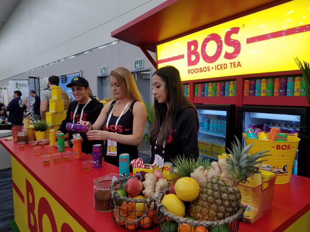 Veronica Chaidez (right) and Erika Kubisch (center) (with third representative) serving BOS samples at the Natural Products Expo West 2018 booth