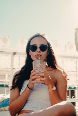 Woman drinking a juice beverage.