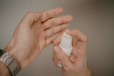 Lotion being applied by hand.