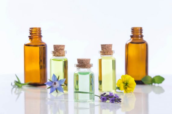 bottles of essential oils against a white background