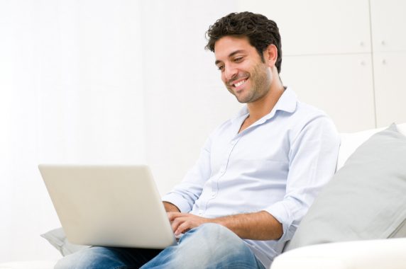 Man on couch with laptop learning how to start an online store
