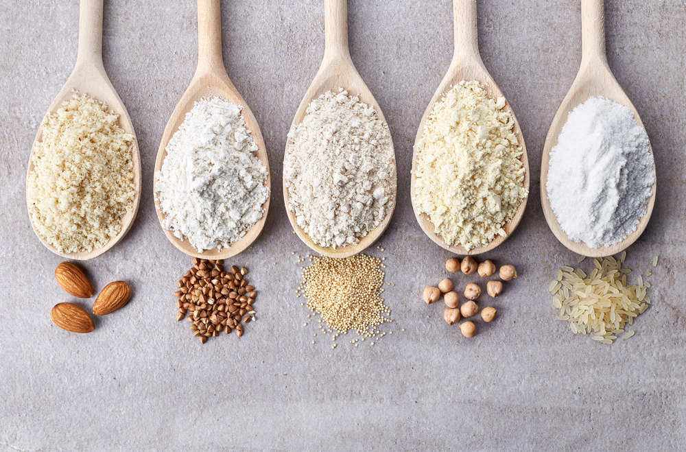 wholesale gluten free flour options displayed in five wooden spoons