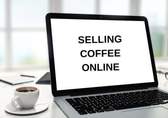 cup of coffee and laptop with screen that reads selling coffee online