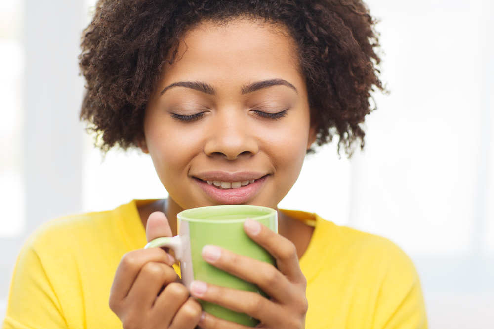 woman drinking coffee from cup list of coffee products to carry in online store