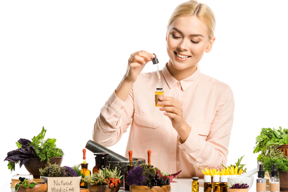 what is homeopathic medicine? a woman making a homeopathic tincture.