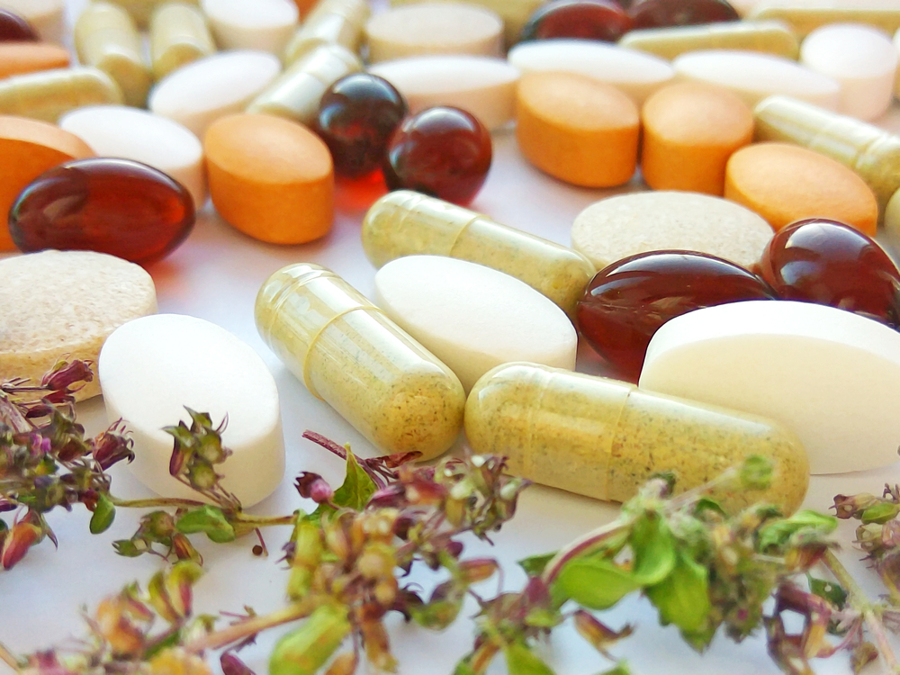 Dropship vitamins. A selection of vitamin capsules and pills on a white table.