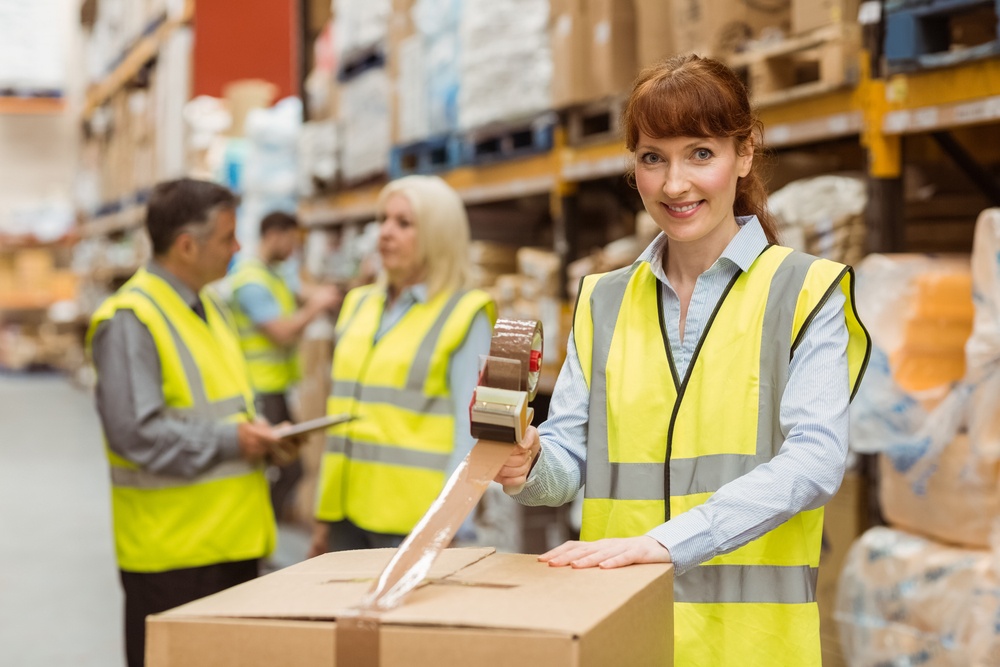 dropshipping supplier woman working in warehouse packing boxes