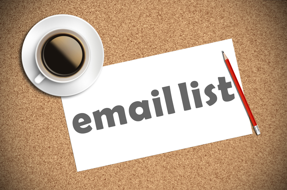 Email marketing for dropshipping: cup of coffee with email subscriber list written  on paper 