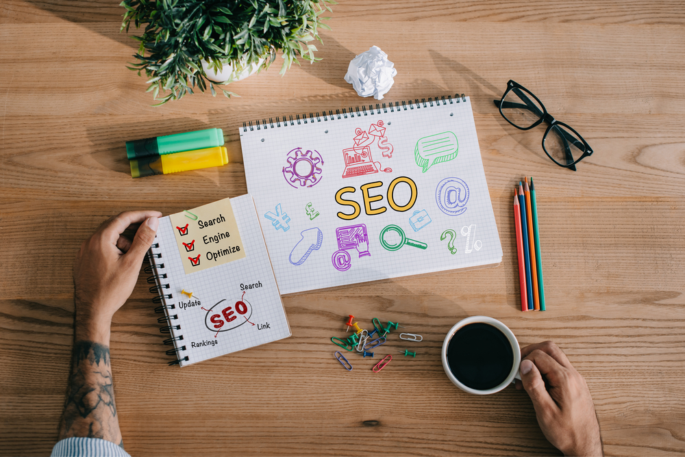 A notebook with the word SEO written in it.  How to increase dropshipping sales, by deploying SEO tactics on your website