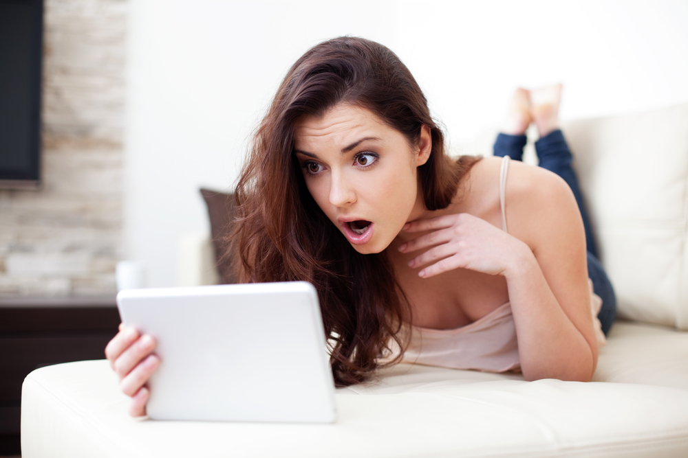 shocked woman looking at a tablet