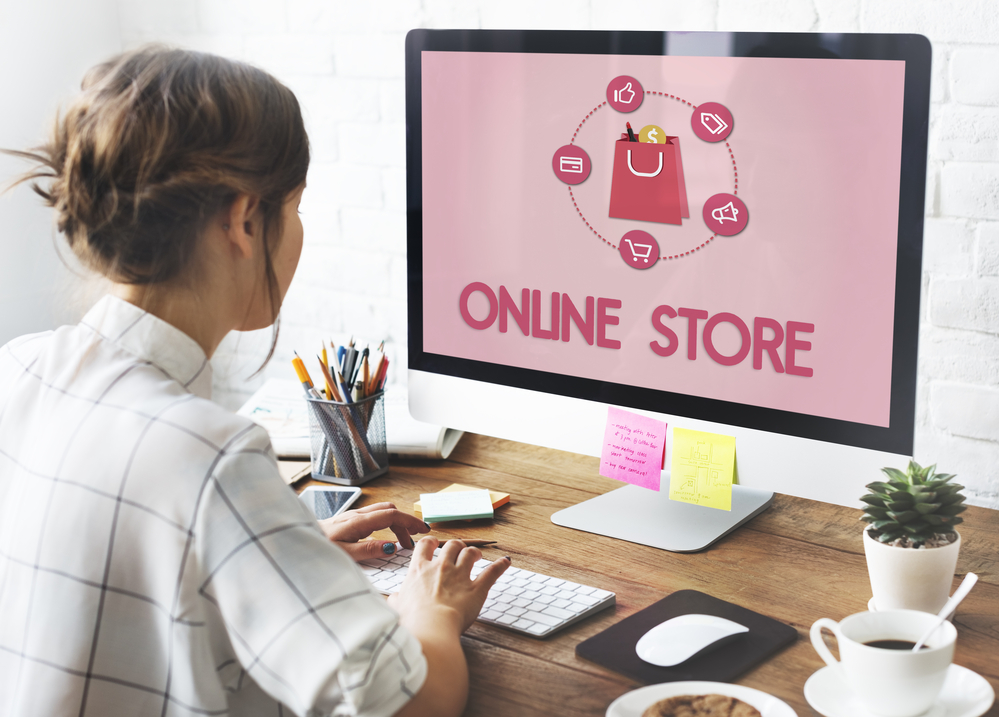 woman building an online store looking at her computer monitor