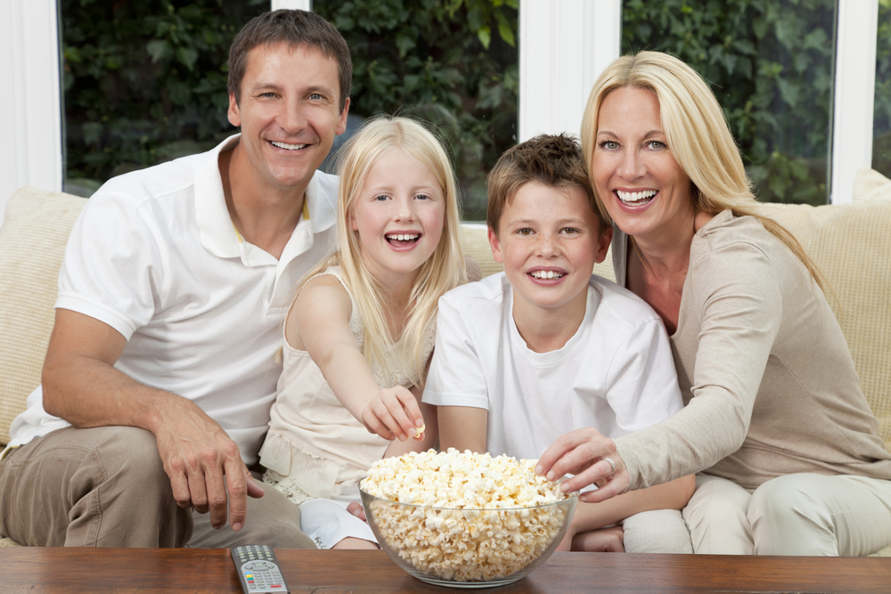 a family eating a bowl of popcorn at home