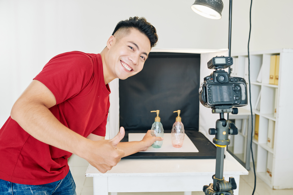 man setting up a video ad shoot with tripod and lighting