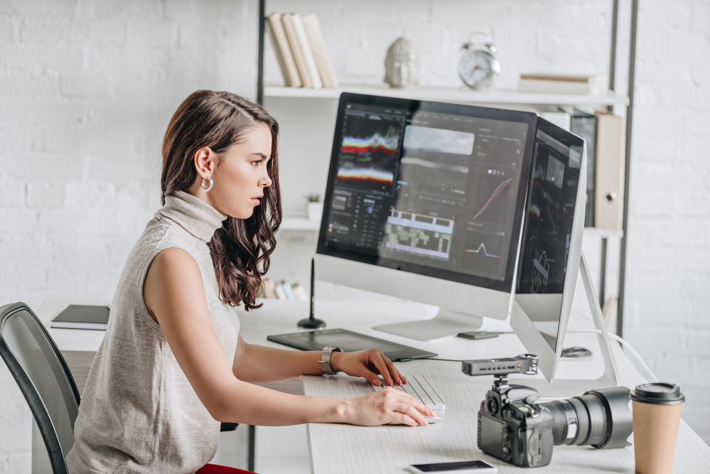 a woman using video editing equipment on her computer