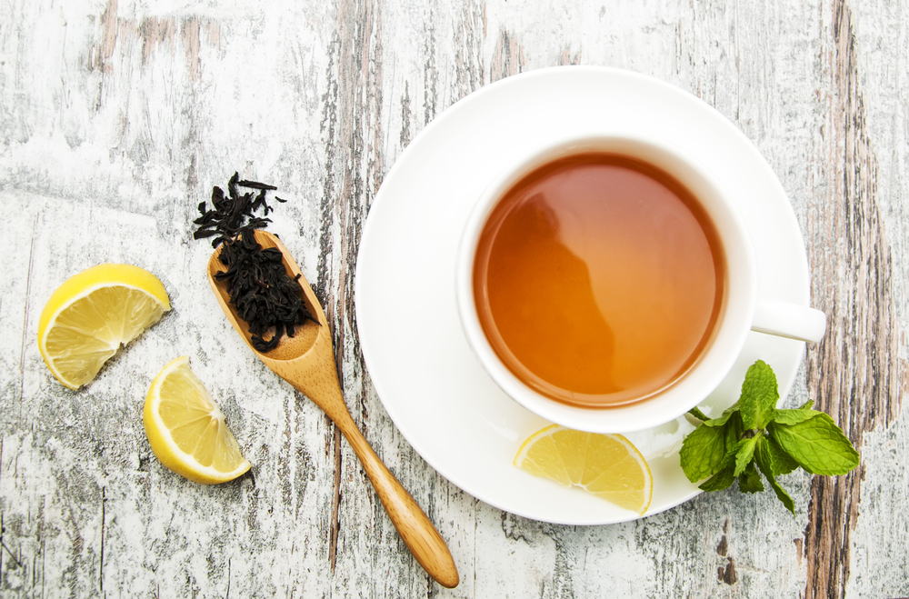 white cup of herbal tea with mint and lemon