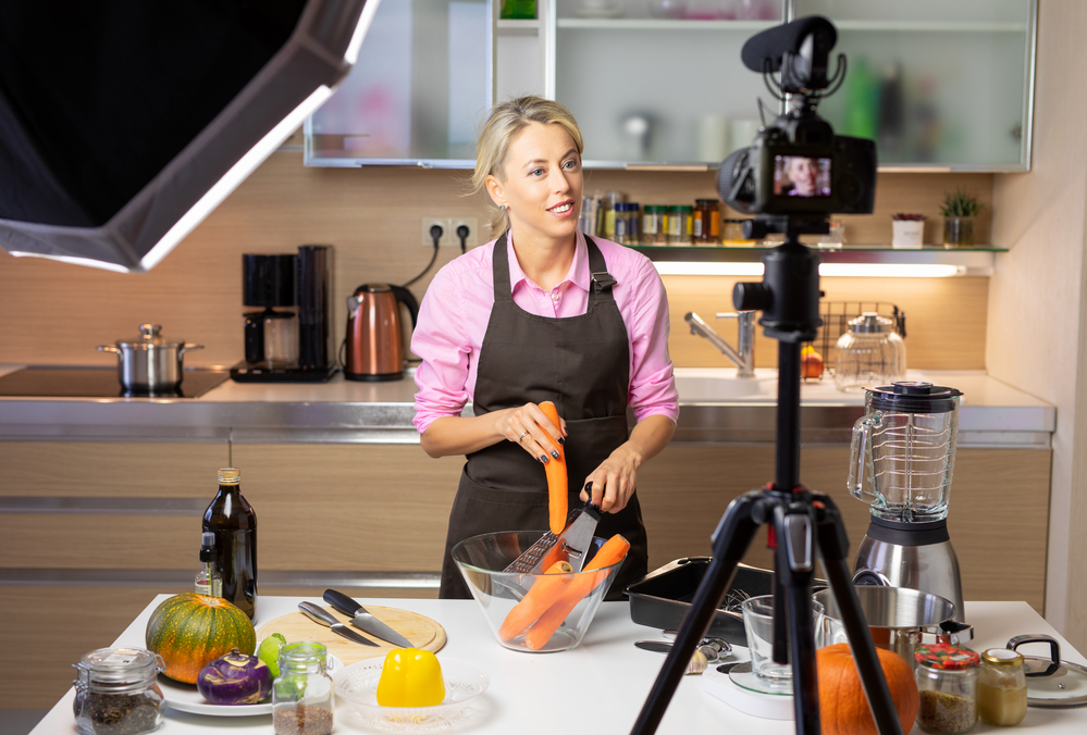 woman making a how to video ad showing a recipe in her kitchen