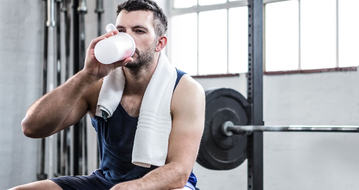 Men drinking protein shake after workout