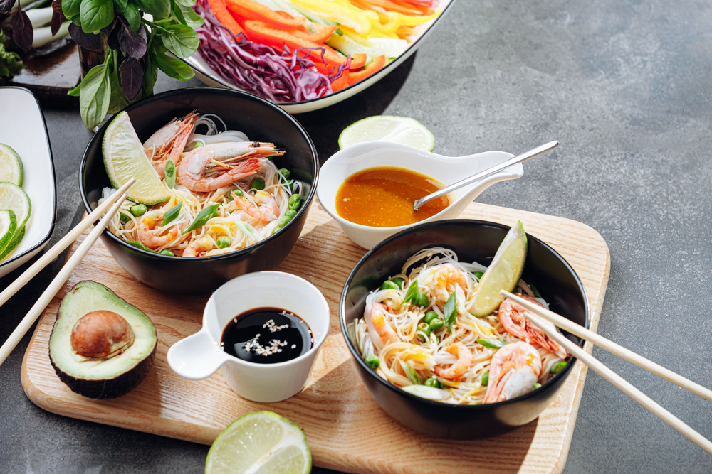 Asian food being served on a wood platter 