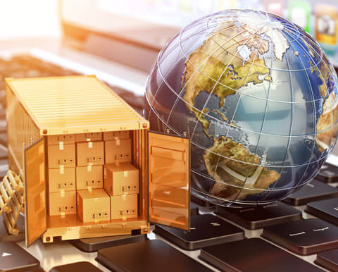 Globe and shipping container full of packages on keyboard